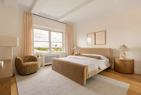 a bedroom with bed and a couch