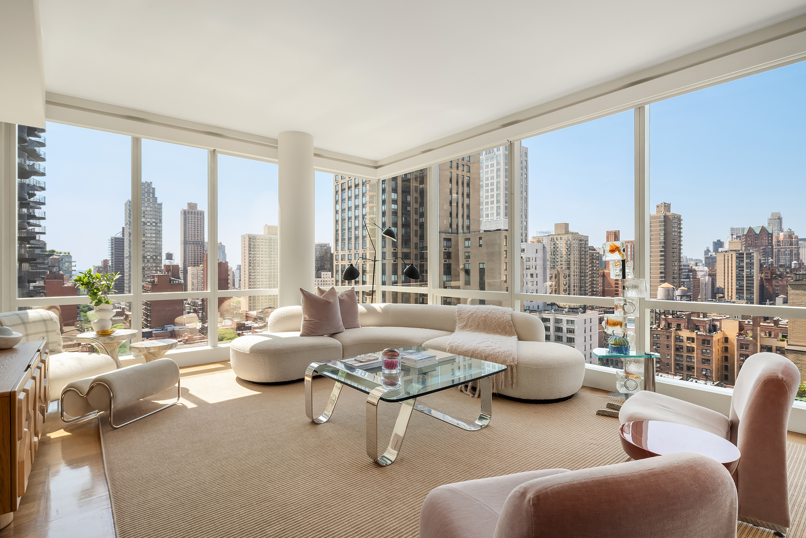 151 East 85th Street, Unit 17B Manhattan, NY 10028 - Photo 1 of 10 a living room with furniture and a large window
