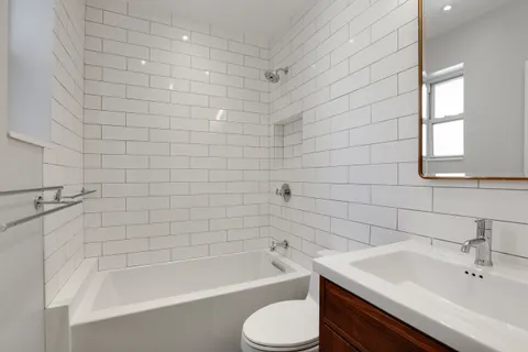 a bathroom with a sink a toilet and bathtub