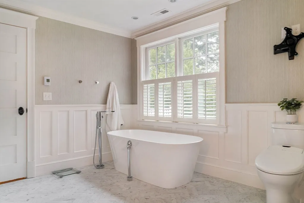 a spacious bedroom with a bed a table and a couch