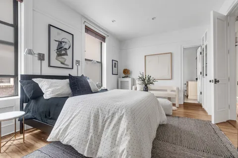 a spacious bedroom with two beds and a table