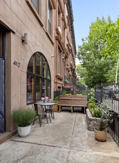 a view of building with outdoor seating and plants