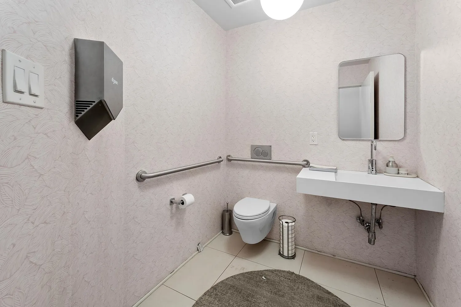 a bathroom with a sink toilet and mirror