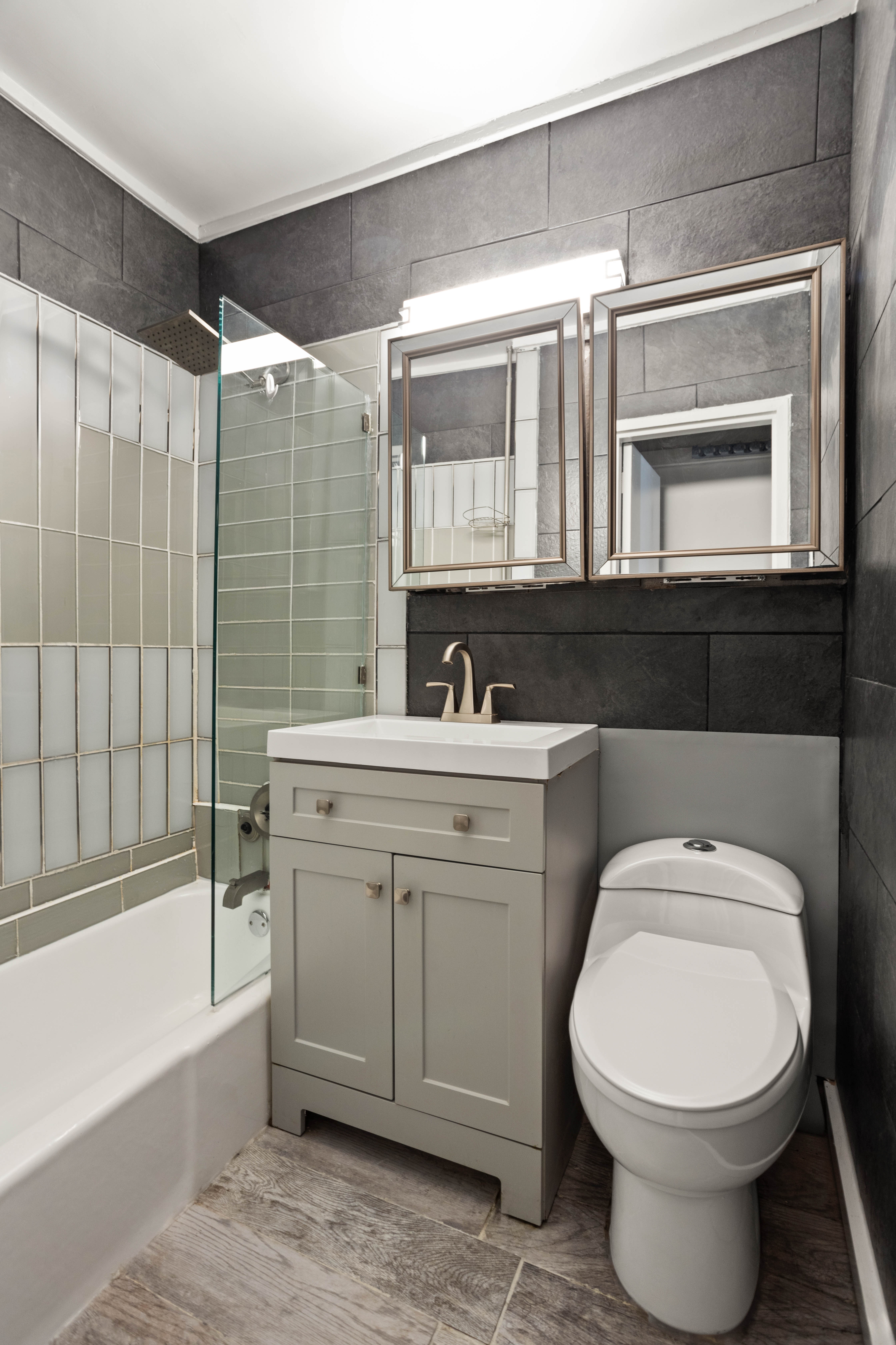 519 East 87th Street, Unit 2C Manhattan, NY 10128 - Photo 5 of 6 a bathroom with a toilet sink and mirror