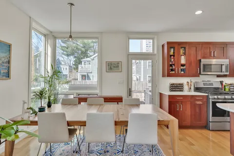 a view of a dining room with furniture window and wooden floor