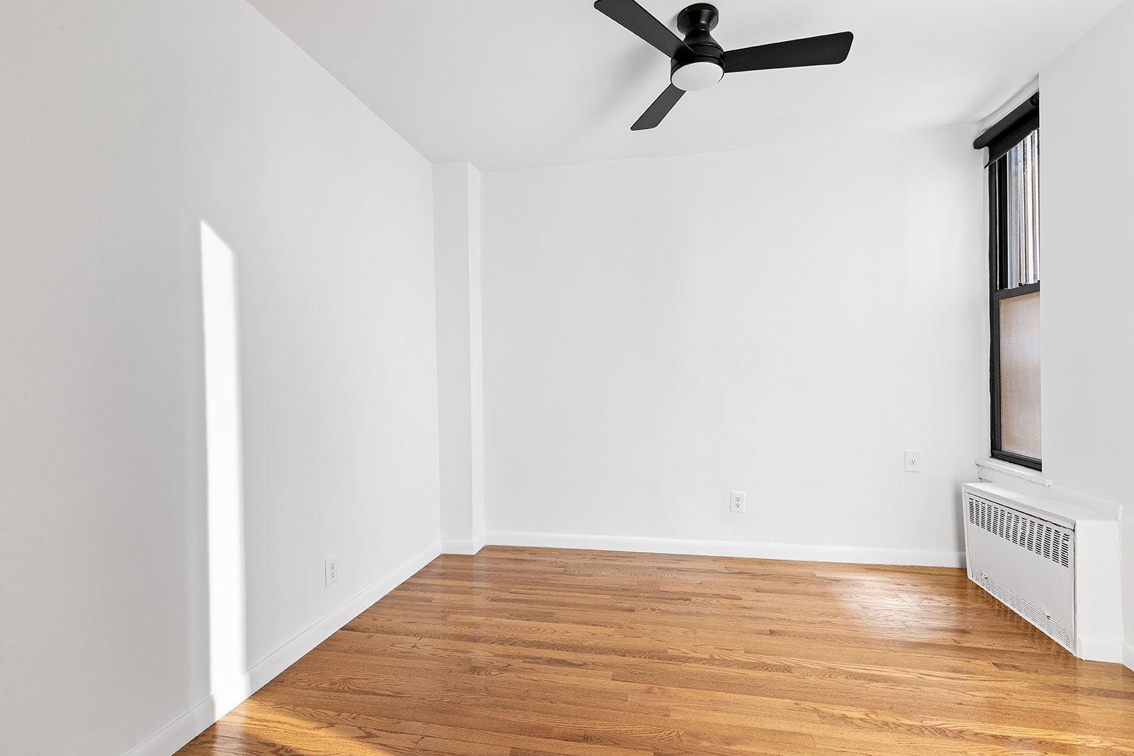 169 Allen Street, Unit 1C Manhattan, NY 10002 - Photo 6 of 12 a view of a room with wooden floor