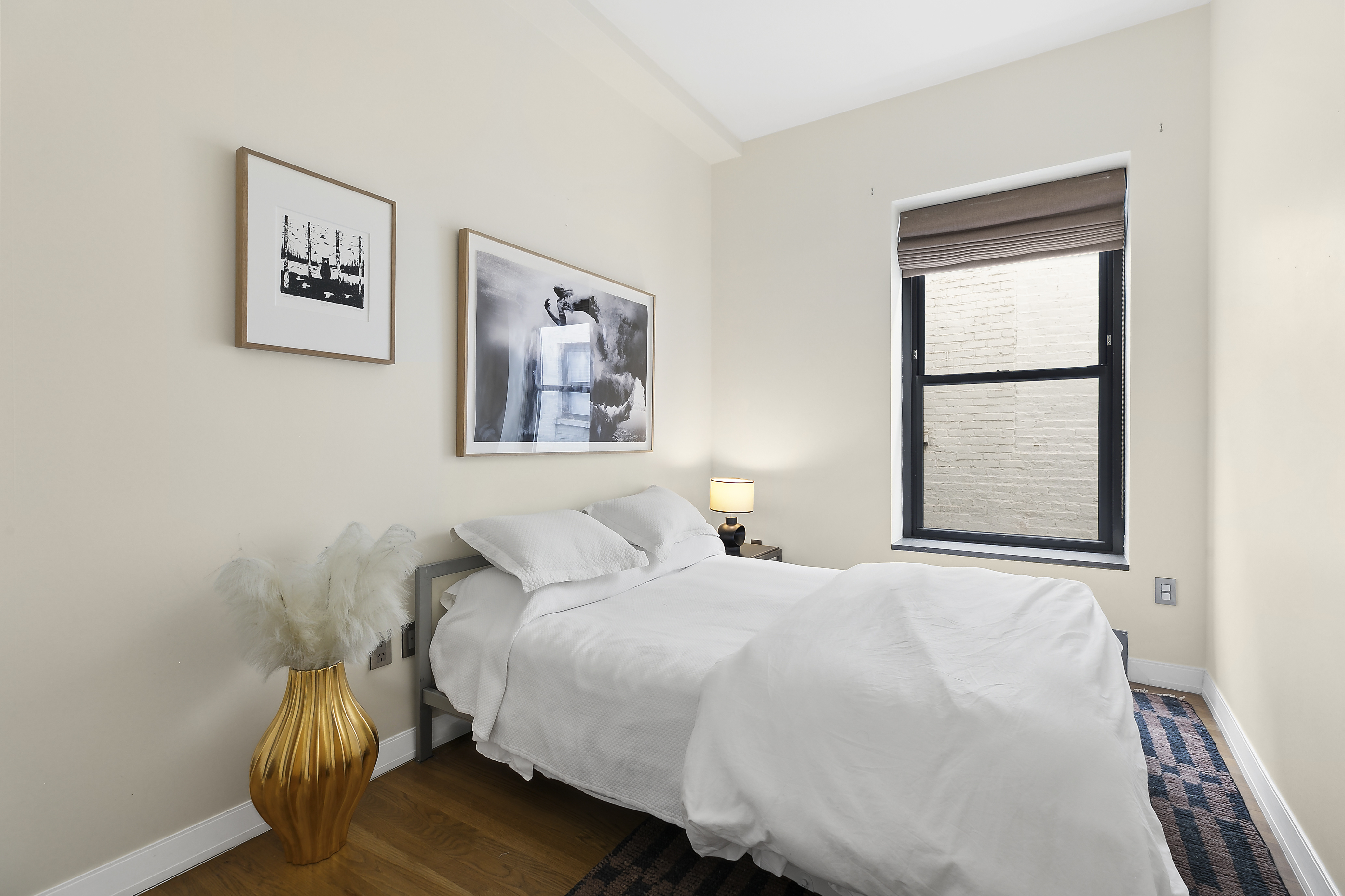 422 West 20th Street, Unit 5A Manhattan, NY 10011 - Photo 7 of 14 a bedroom with a bed and a window