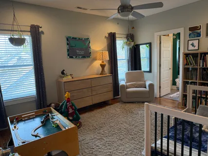 a bedroom with furniture and a window