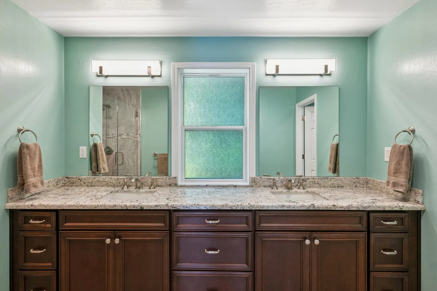 a view of a lake with houses in the back