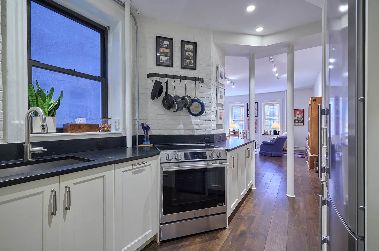 a kitchen with a stove and a wooden floor