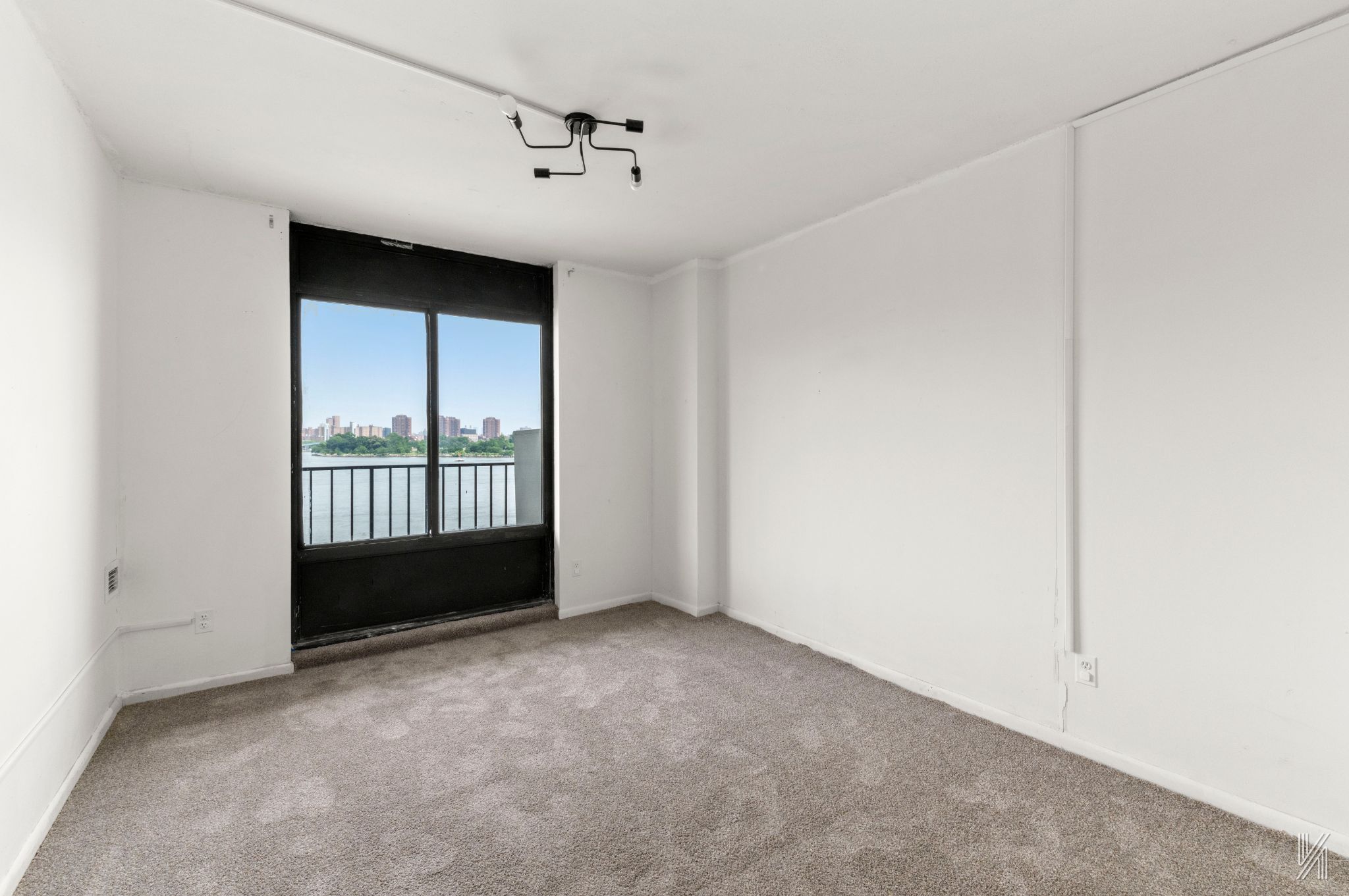 25-40 Shore Boulevard, Unit 4R Queens, NY 11102 - Photo 5 of 11 a view of an empty room with a window