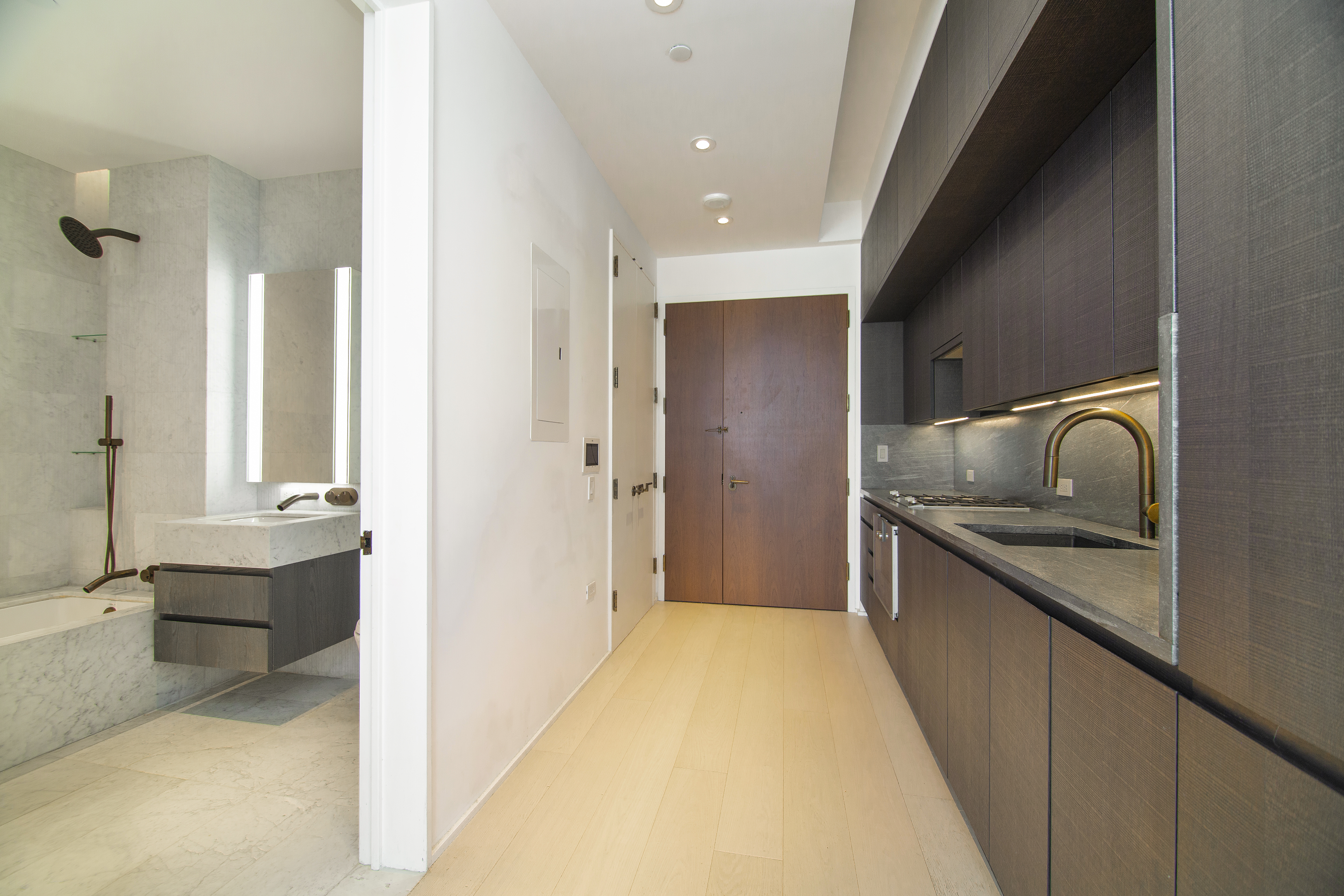 130 William Street, Unit 9E Manhattan, NY 10038 - Photo 8 of 16 a bathroom with a granite countertop sink a toilet and shower