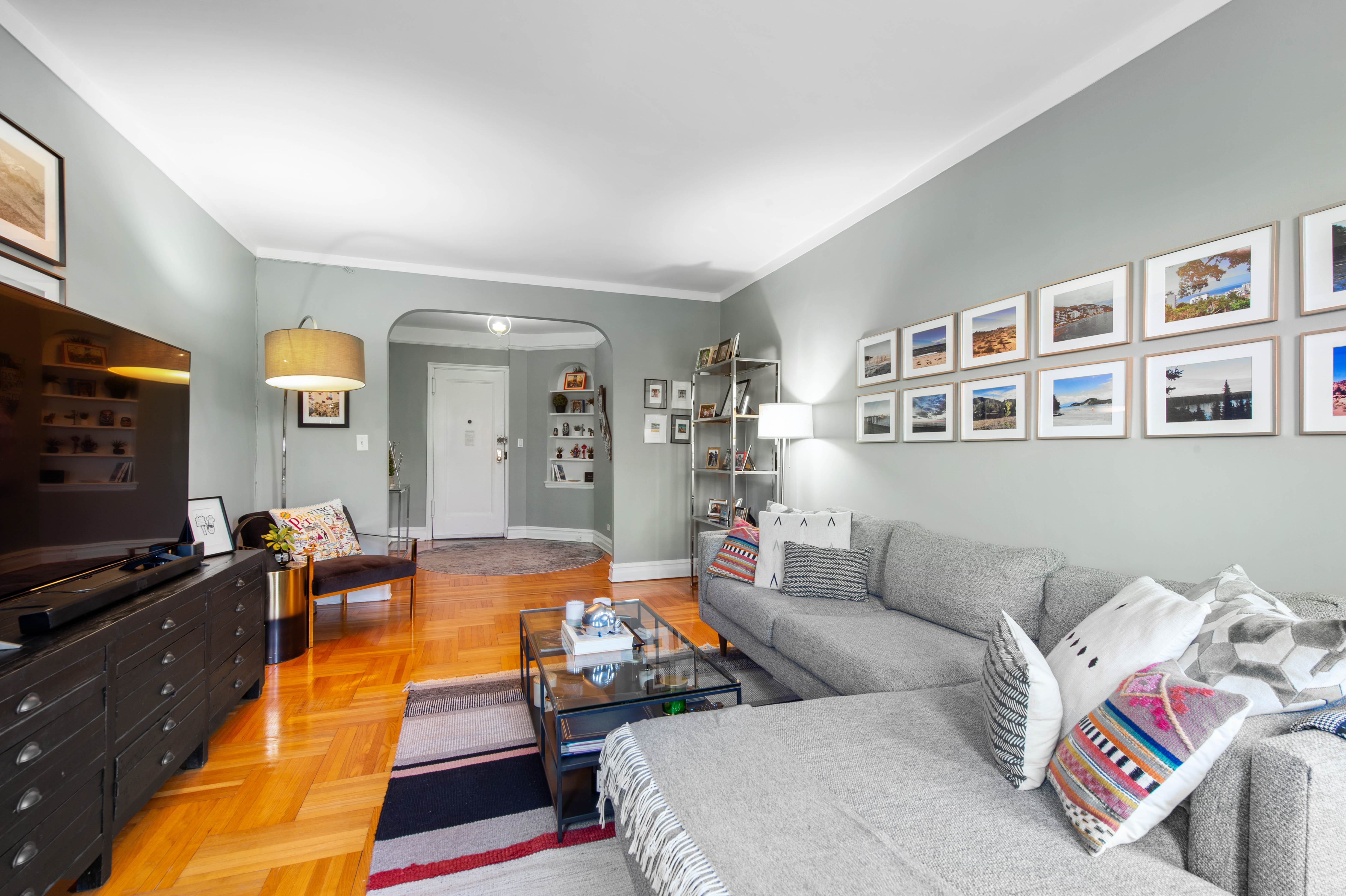 35-06 88th Street, Unit 6B Queens, NY 11372 - Photo 2 of 9 a living room with furniture and a flat screen tv