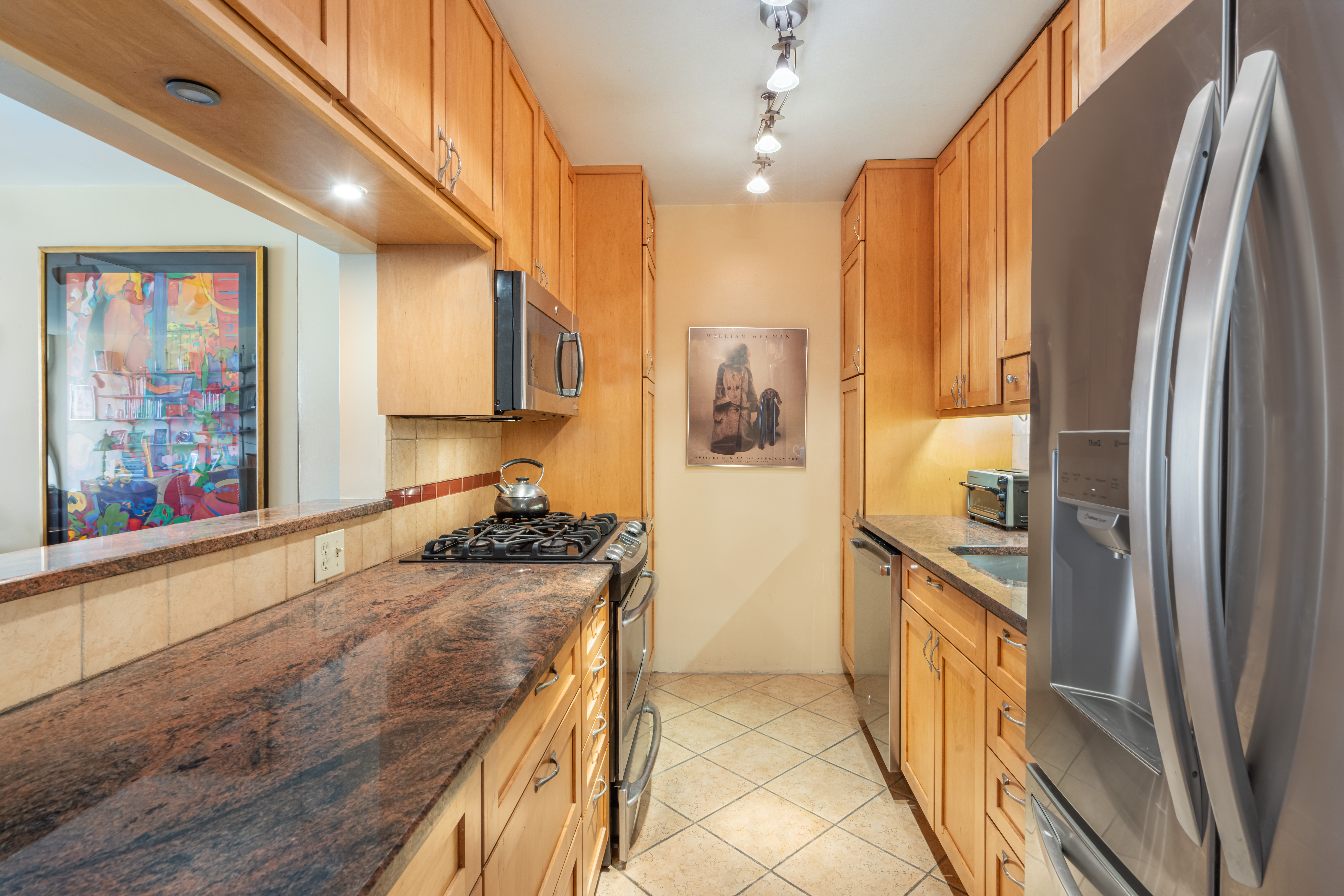 330 East 33rd Street, Unit 7C Manhattan, NY 10016 - Photo 4 of 18 a kitchen with stainless steel appliances granite countertop a refrigerator and a stove
