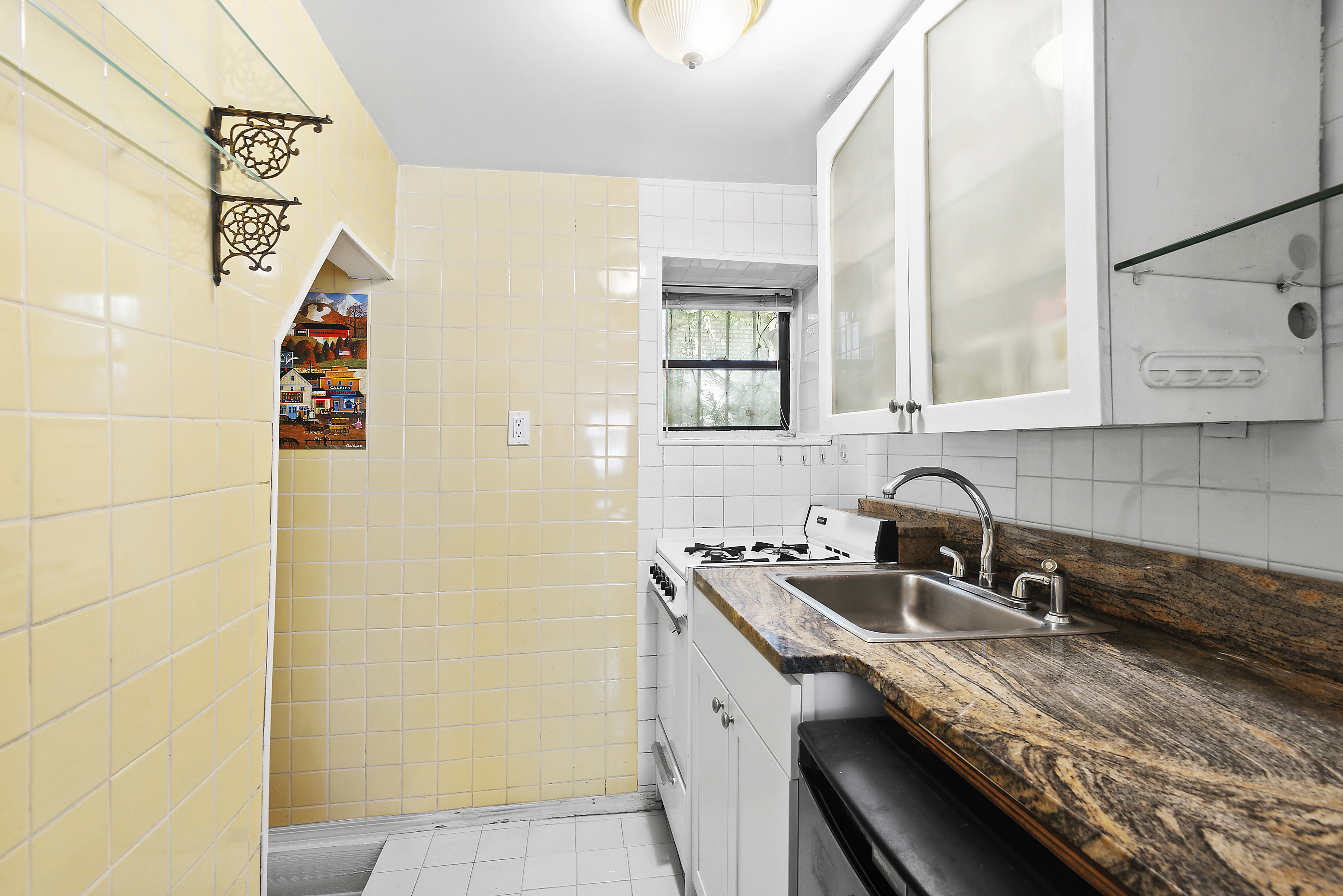 309 West 20th Street, Unit 1R Manhattan, NY 10011 - Photo 5 of 10 a kitchen with stainless steel appliances granite countertop a sink and a white cabinets