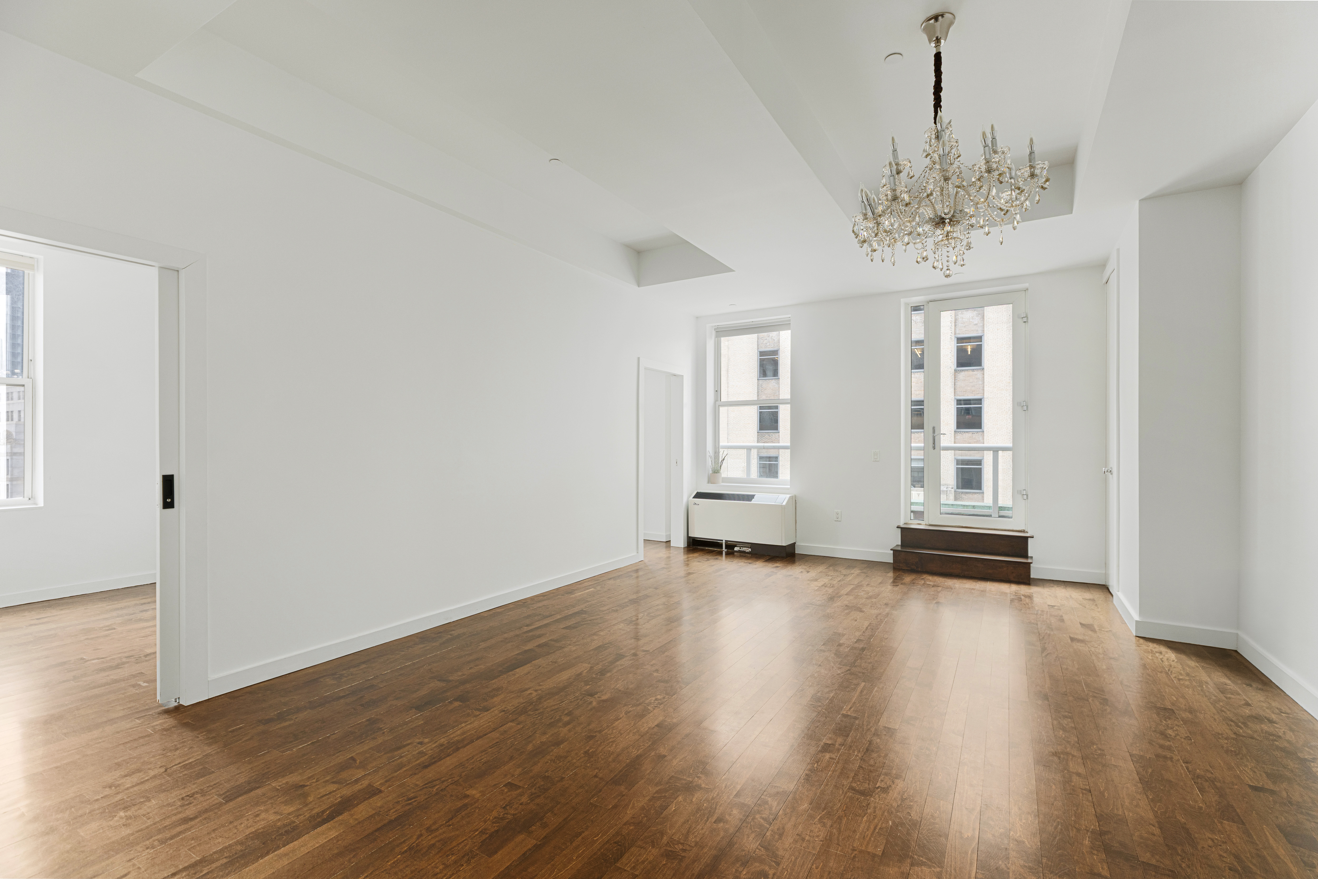 15 Broad Street, Unit 2300 Manhattan, NY 10005 - Photo 2 of 36 wooden floor in an empty room with a window