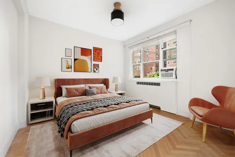 a bedroom with a bed a chair and a window