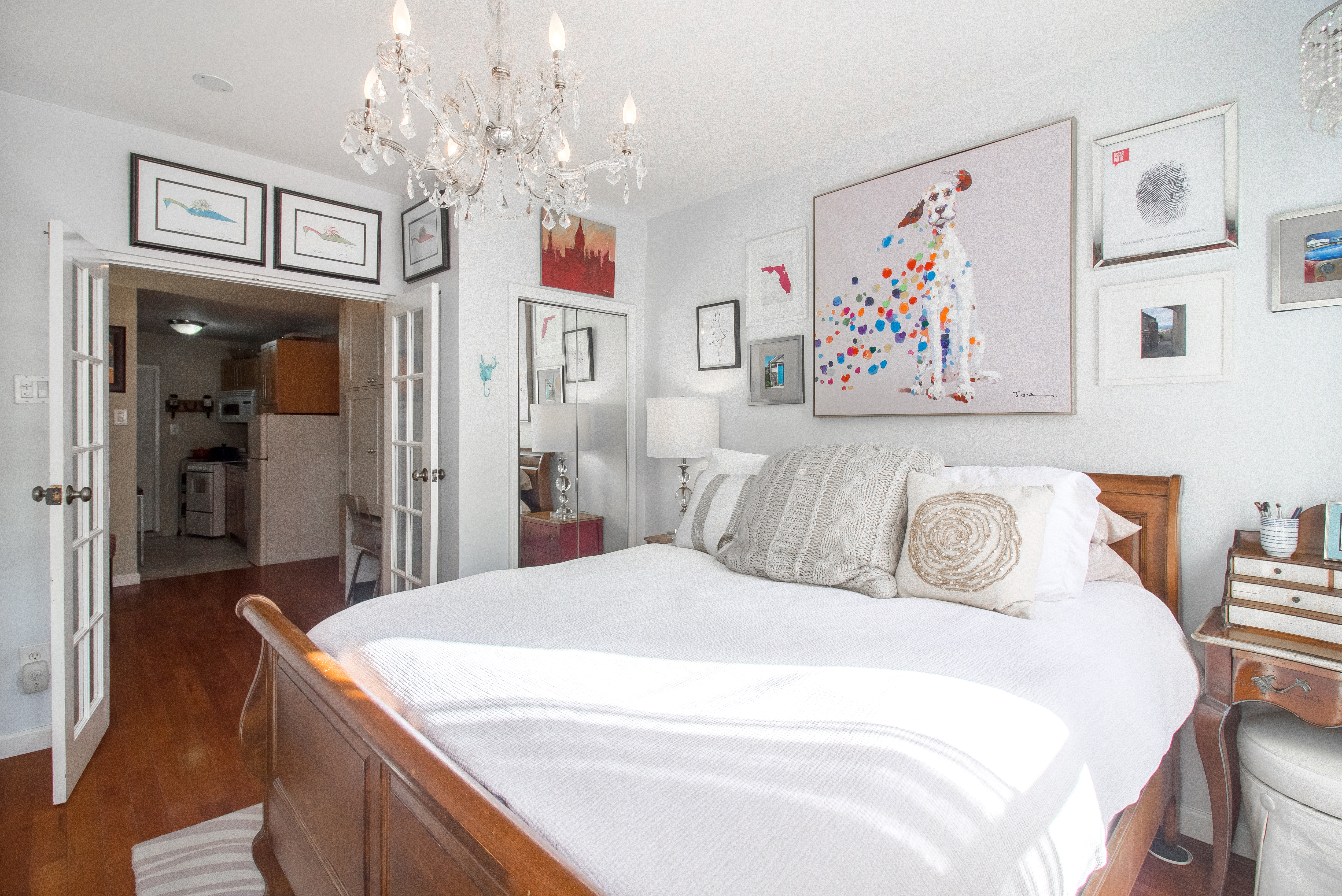 246 East 90th Street, Unit 5C Manhattan, NY 10128 - Photo 8 of 13 a spacious bedroom with a bed and a chandelier