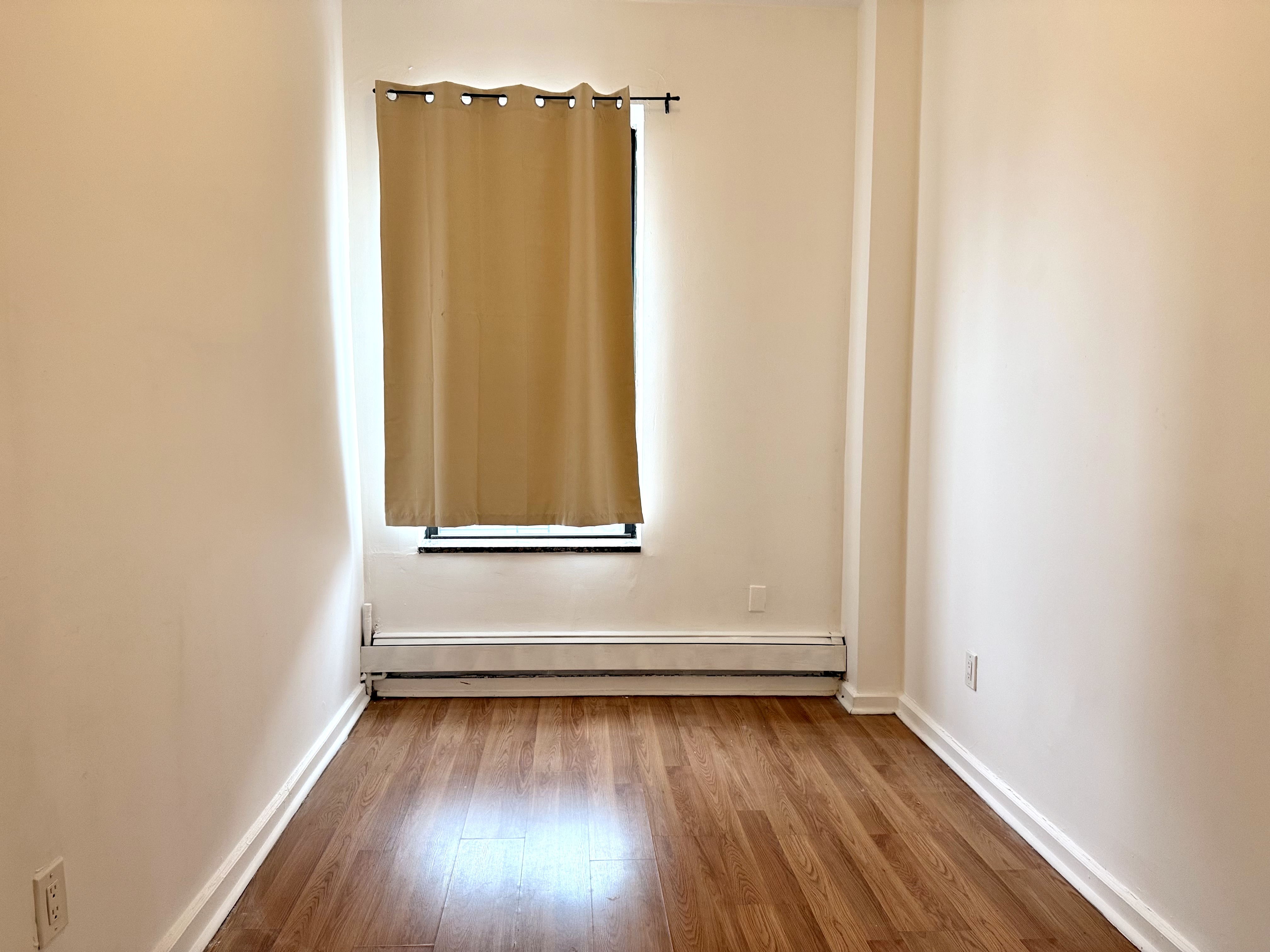 1997 3rd Avenue, Unit 1A Manhattan, NY 10029 - Photo 22 of 23 a view of a room with wooden floor and window