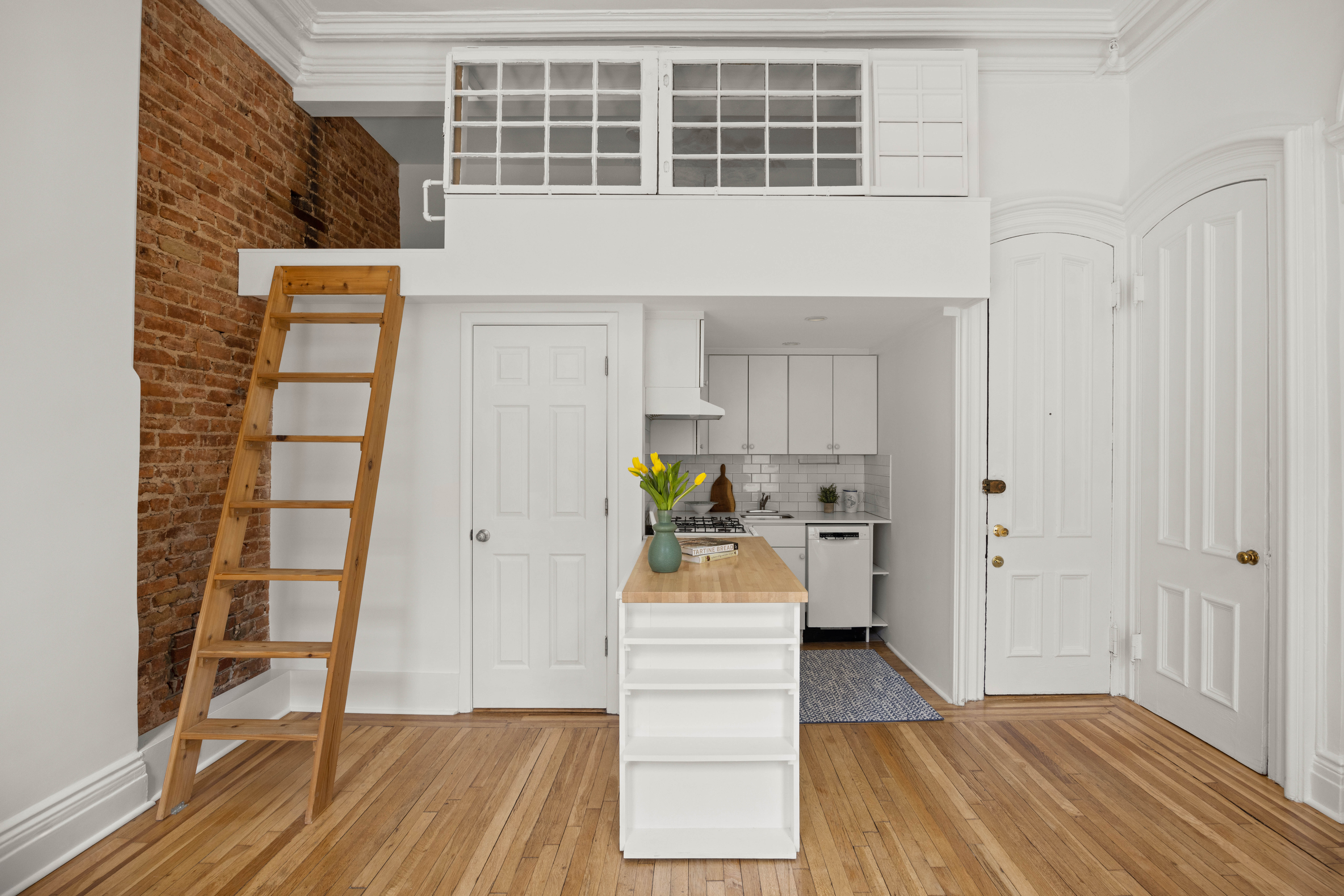 144 Park Place, Unit 3 Brooklyn, NY 11217 - Photo 3 of 6 a hallway with a white cabinets and wooden floor