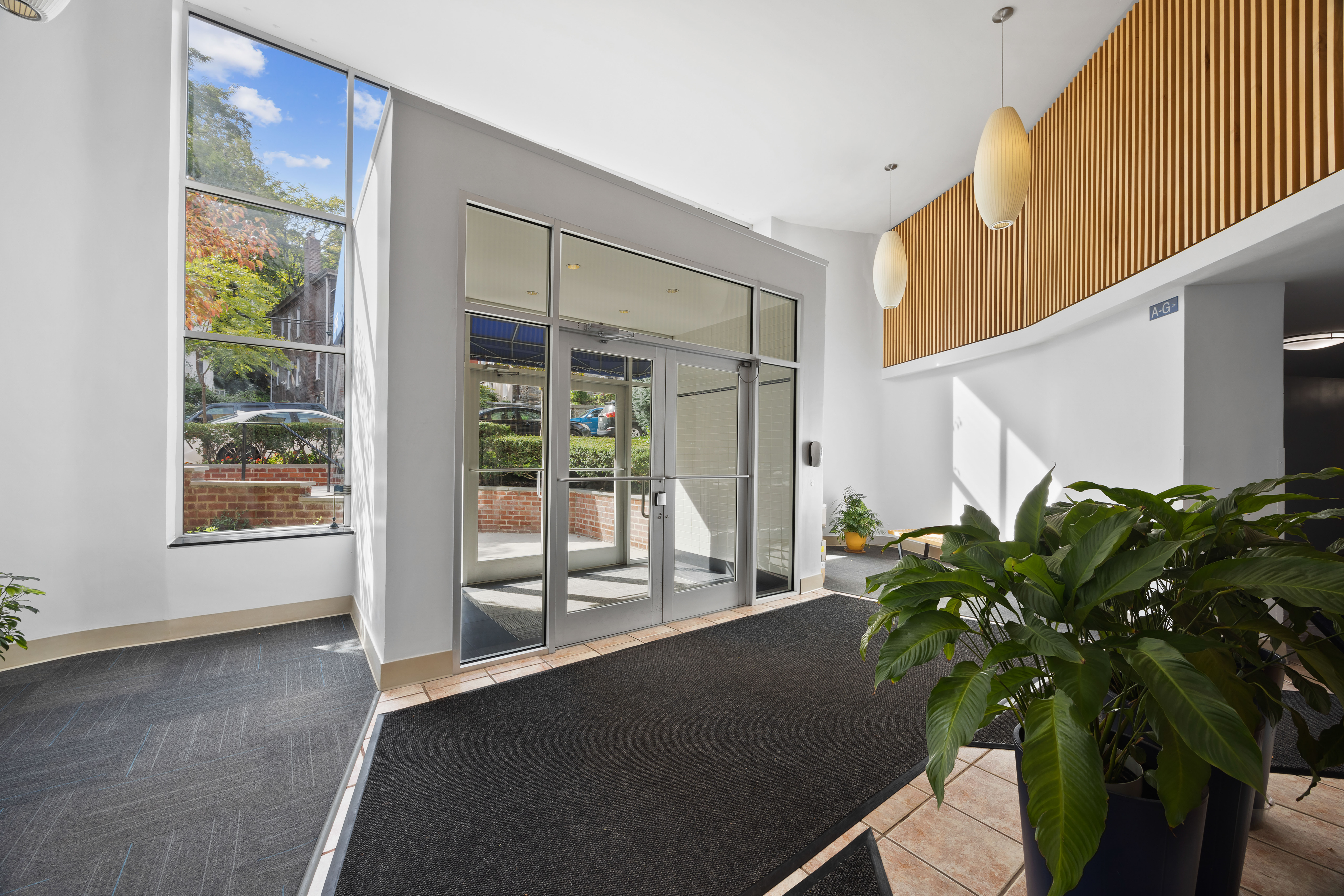 255 Fieldston Terrace, Unit 2L Bronx, NY 10471 - Photo 30 of 32 a living room filled with furniture and a potted plant