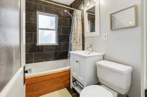 a white toilet sitting next to a bathroom sink and tub