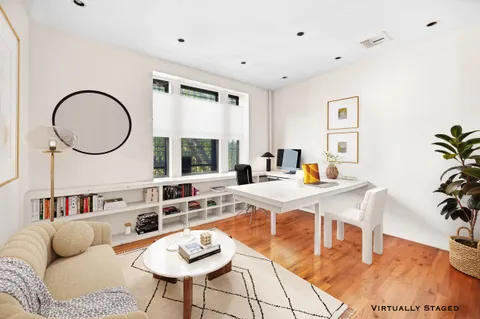 a living room with furniture a dining table and a large window