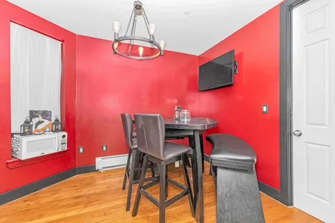a view of a dining room with furniture and chandelier