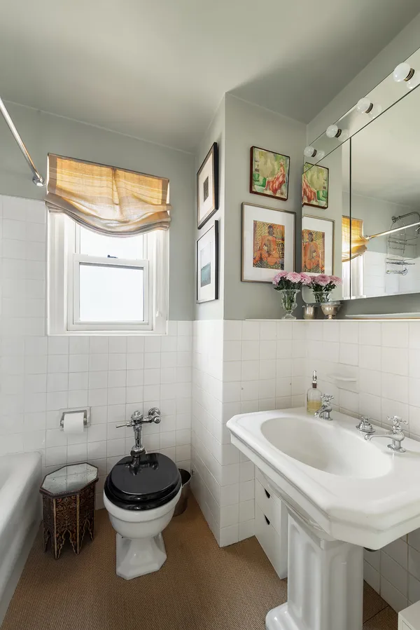 a bathroom with a sink a toilet and a mirror