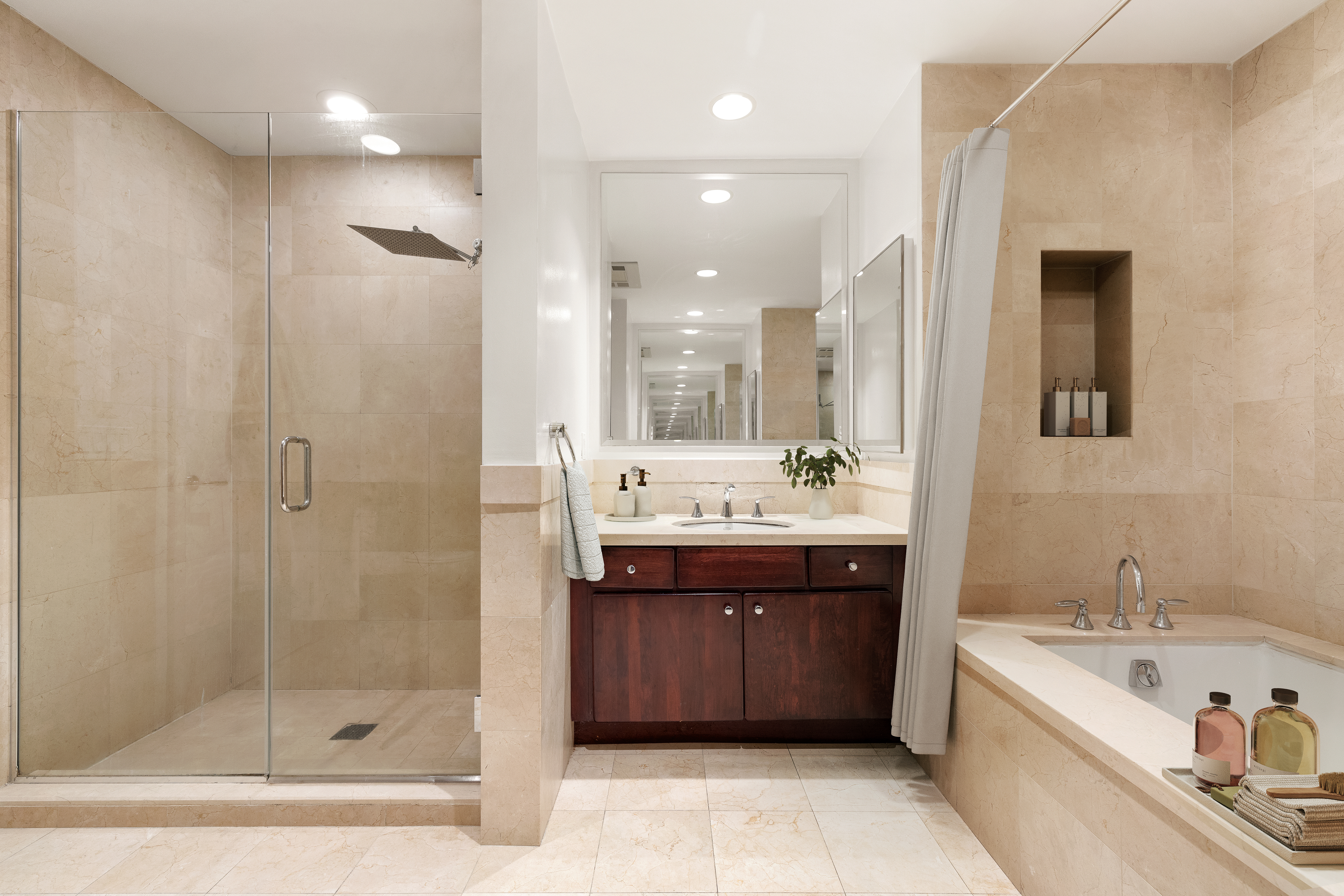 73 Worth Street, Unit 5E Manhattan, NY 10013 - Photo 6 of 10 a bathroom with a bathtub shower sink and mirror
