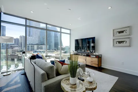 a living room with furniture and a wooden floor
