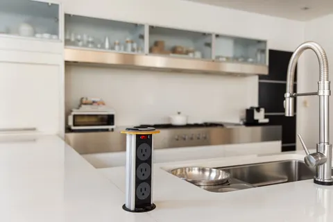 a view of a kitchen with kitchen island a sink and wooden floor