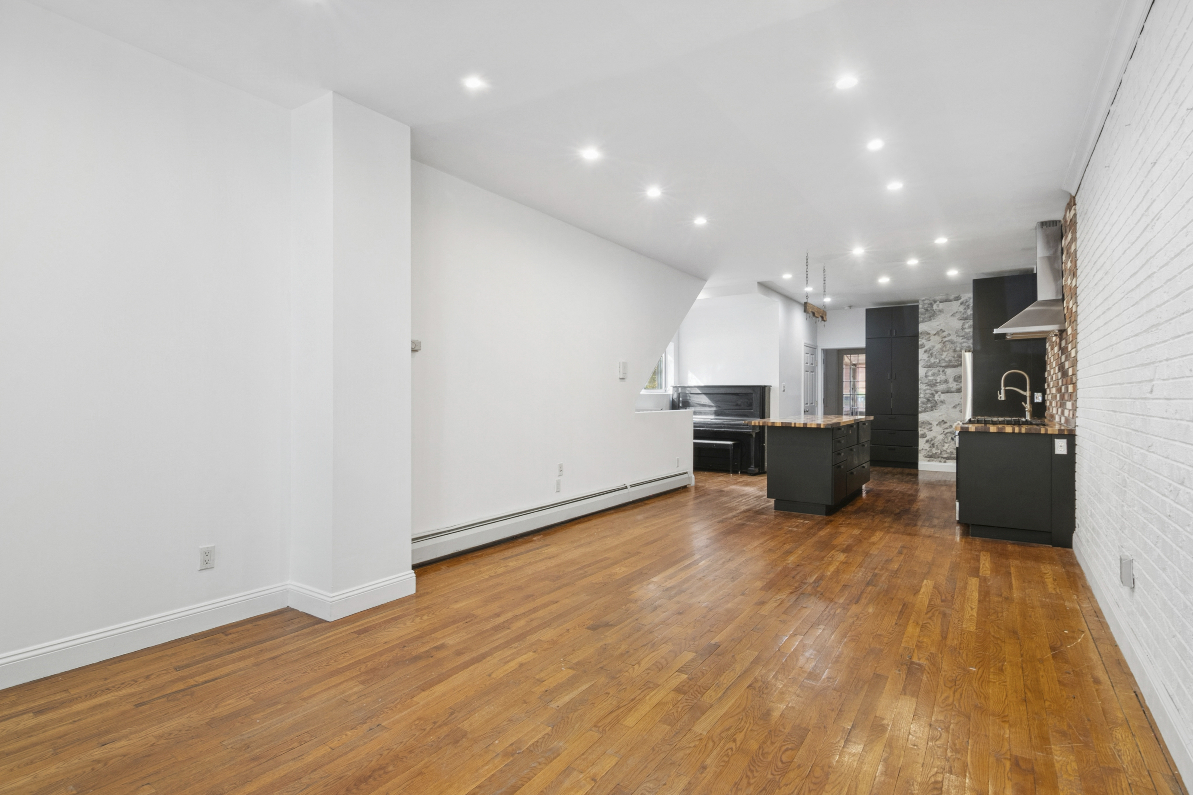 594 6th Avenue, Unit 1 Brooklyn, NY 11215 - Photo 2 of 13 a view of kitchen with kitchen island microwave and refrigerator