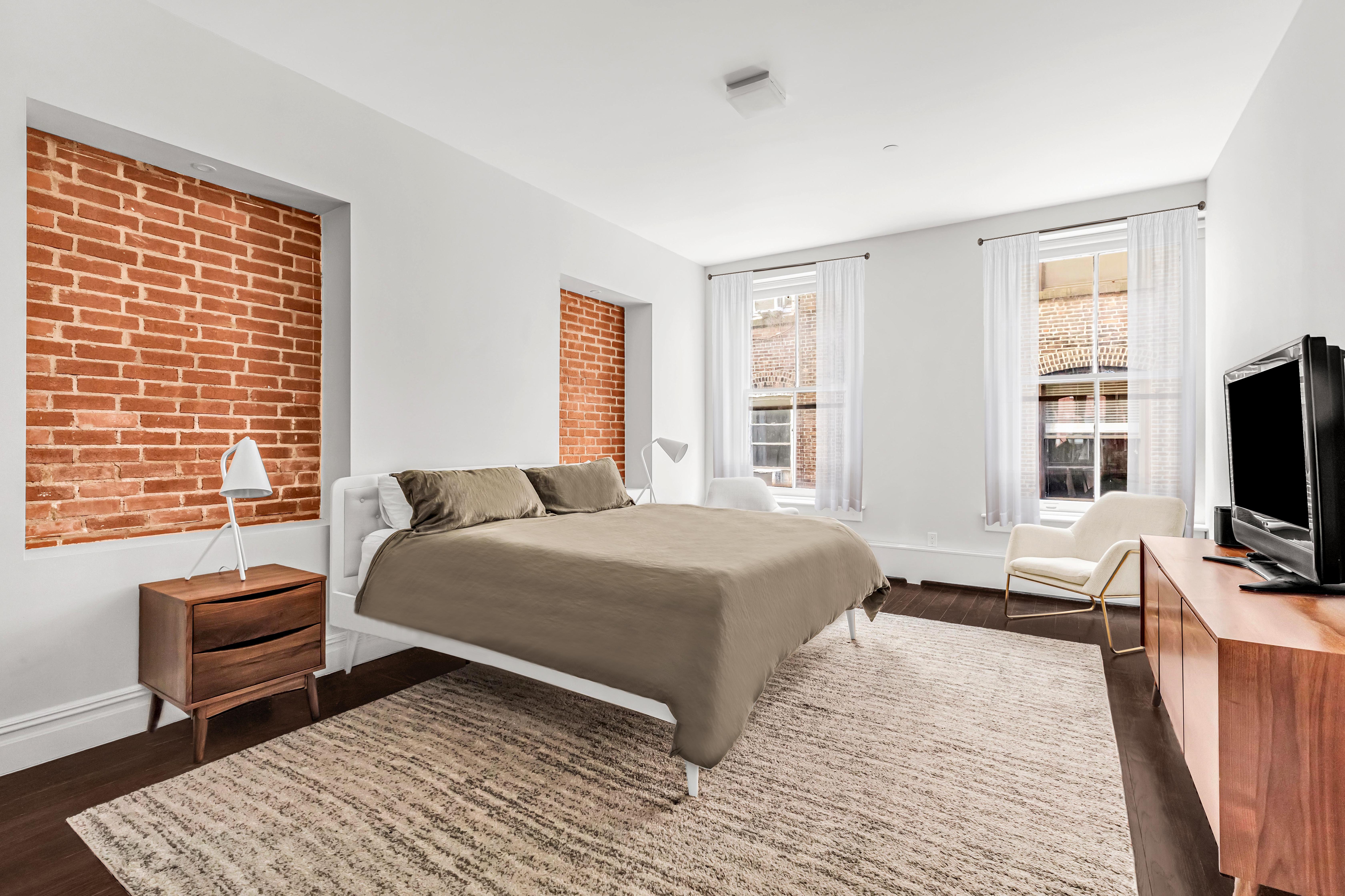 175 Franklin Street, Unit 4 Manhattan, NY 10013 - Photo 4 of 13 a bedroom with a bed television and a window