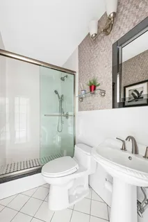 a bathroom with a sink toilet and shower