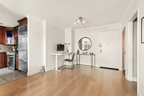 a view of a livingroom with furniture and a kitchen