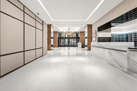 a view of an entryway with a floor to ceiling window