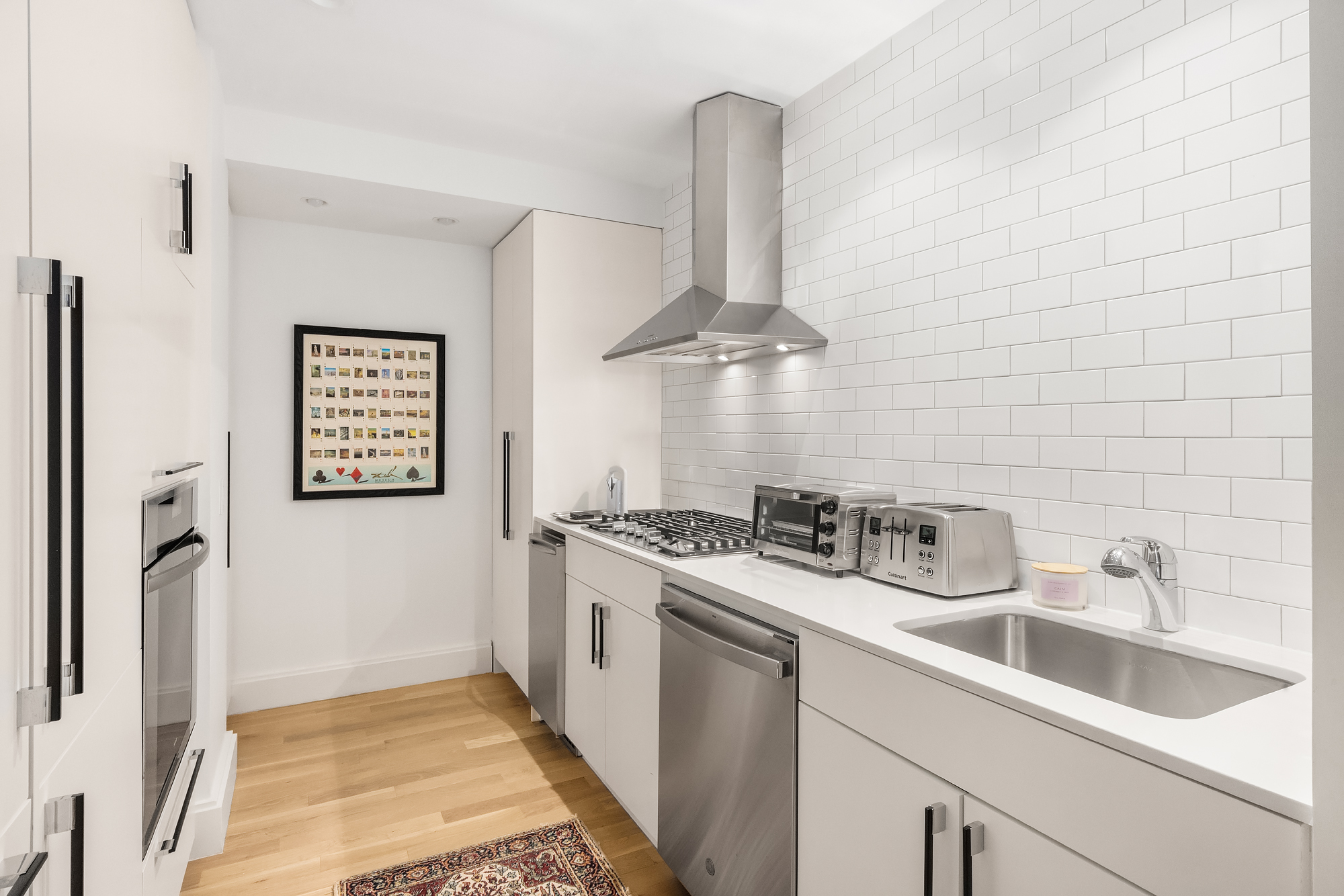 110 Central Park South, Unit 12ABC Manhattan, NY 10019 - Photo 26 of 49 a kitchen with stainless steel appliances granite countertop a sink stove and refrigerator