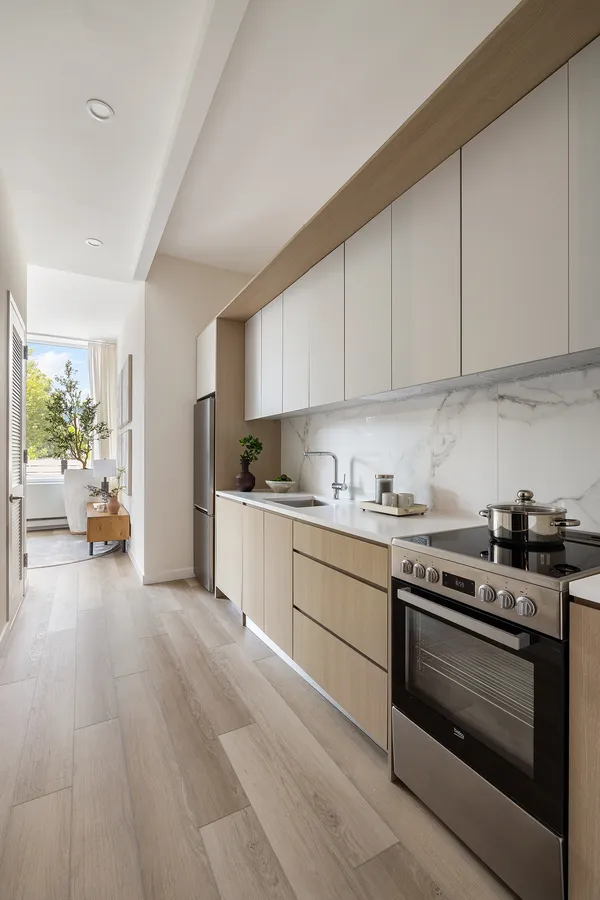 a kitchen with a stove a sink and a refrigerator