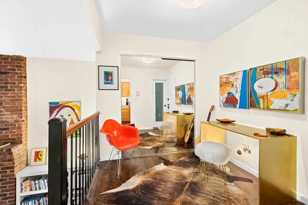 a living room with furniture and painting on the wall