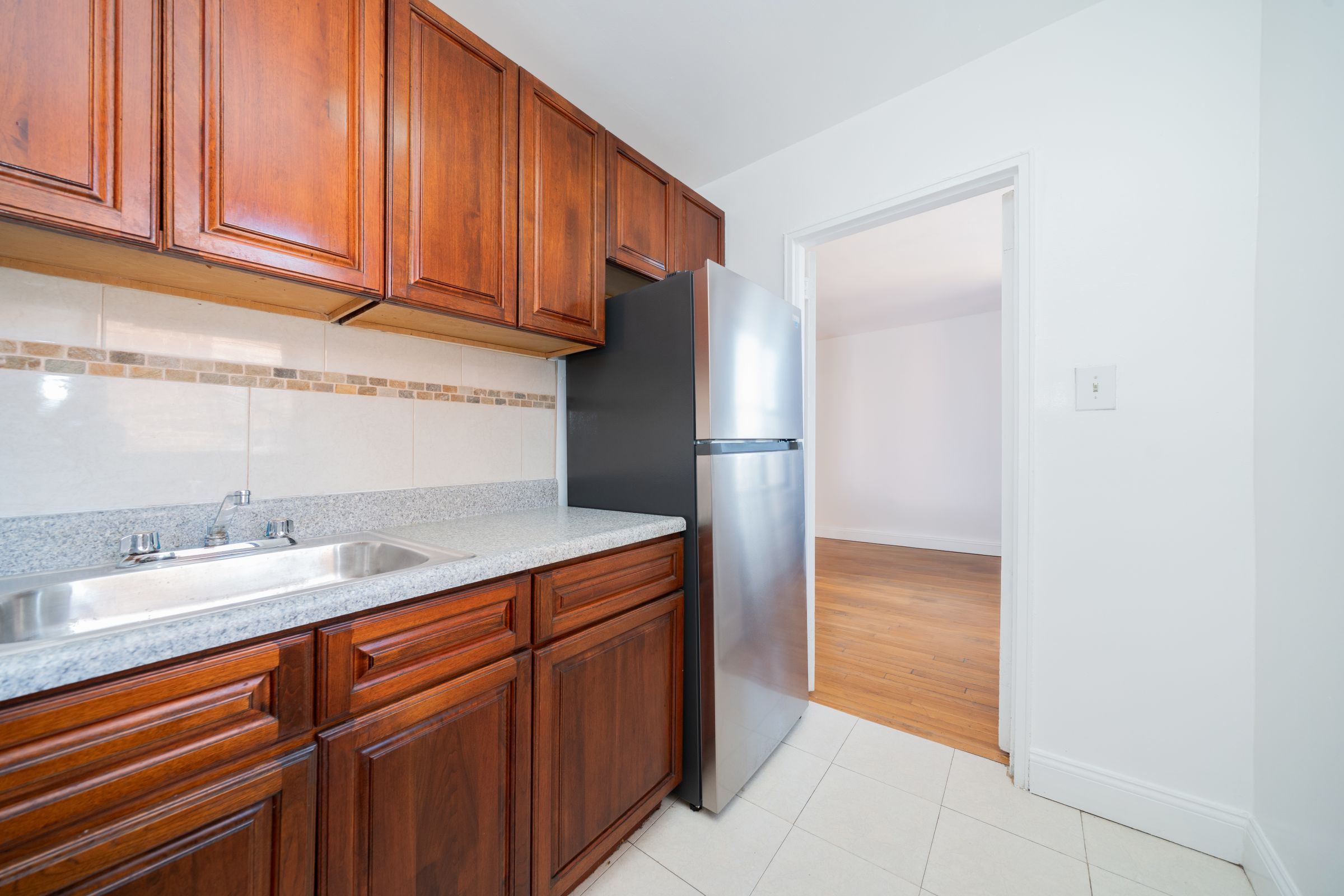 1270 East 51st Street, Unit 6M Brooklyn, NY 11234 - Photo 6 of 12 a kitchen with stainless steel appliances granite countertop a refrigerator and a sink