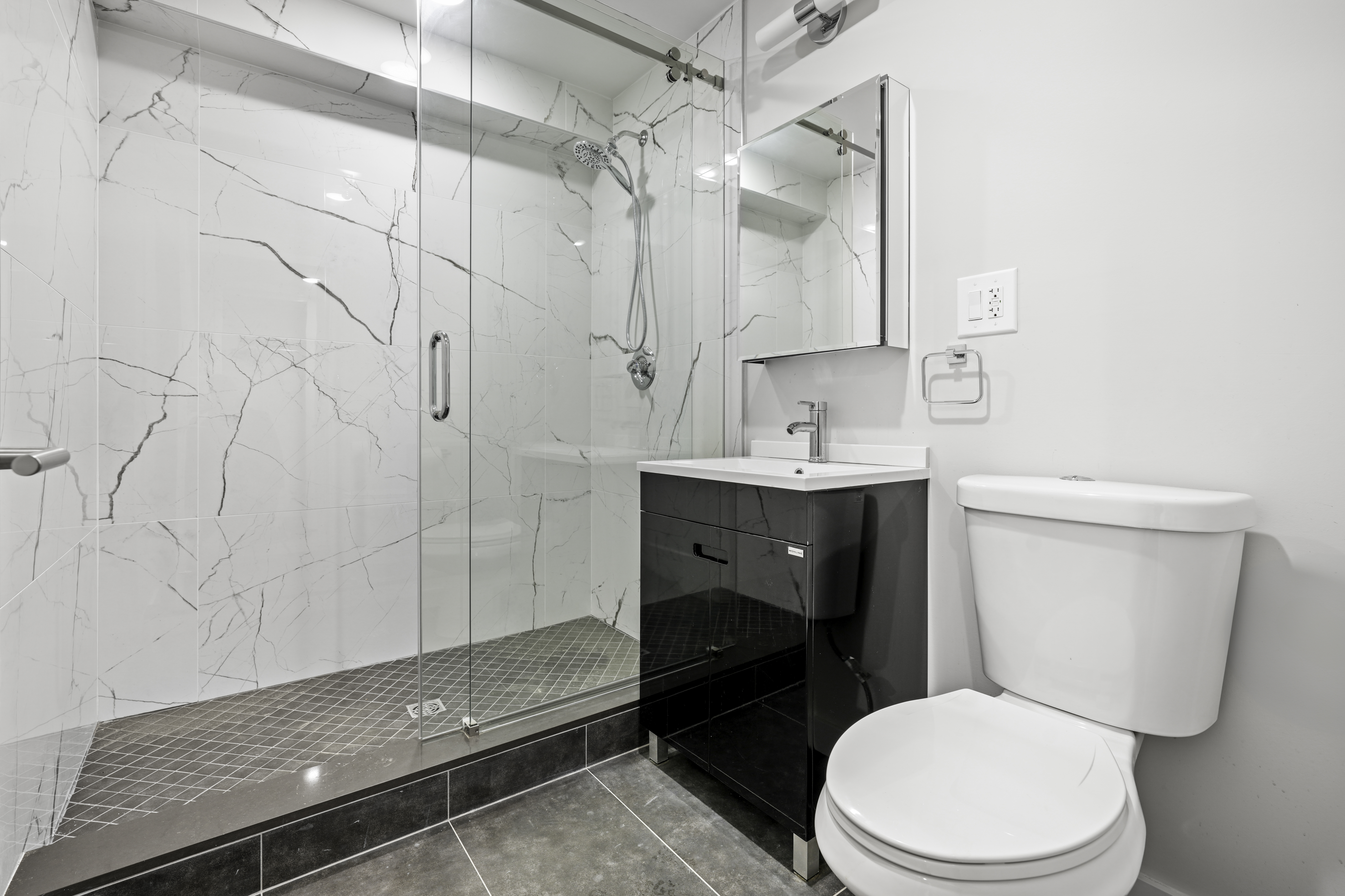 950 St Nicholas Avenue, Unit 1 Manhattan, NY 10032 - Photo 12 of 16 a bathroom with a toilet a sink and mirror