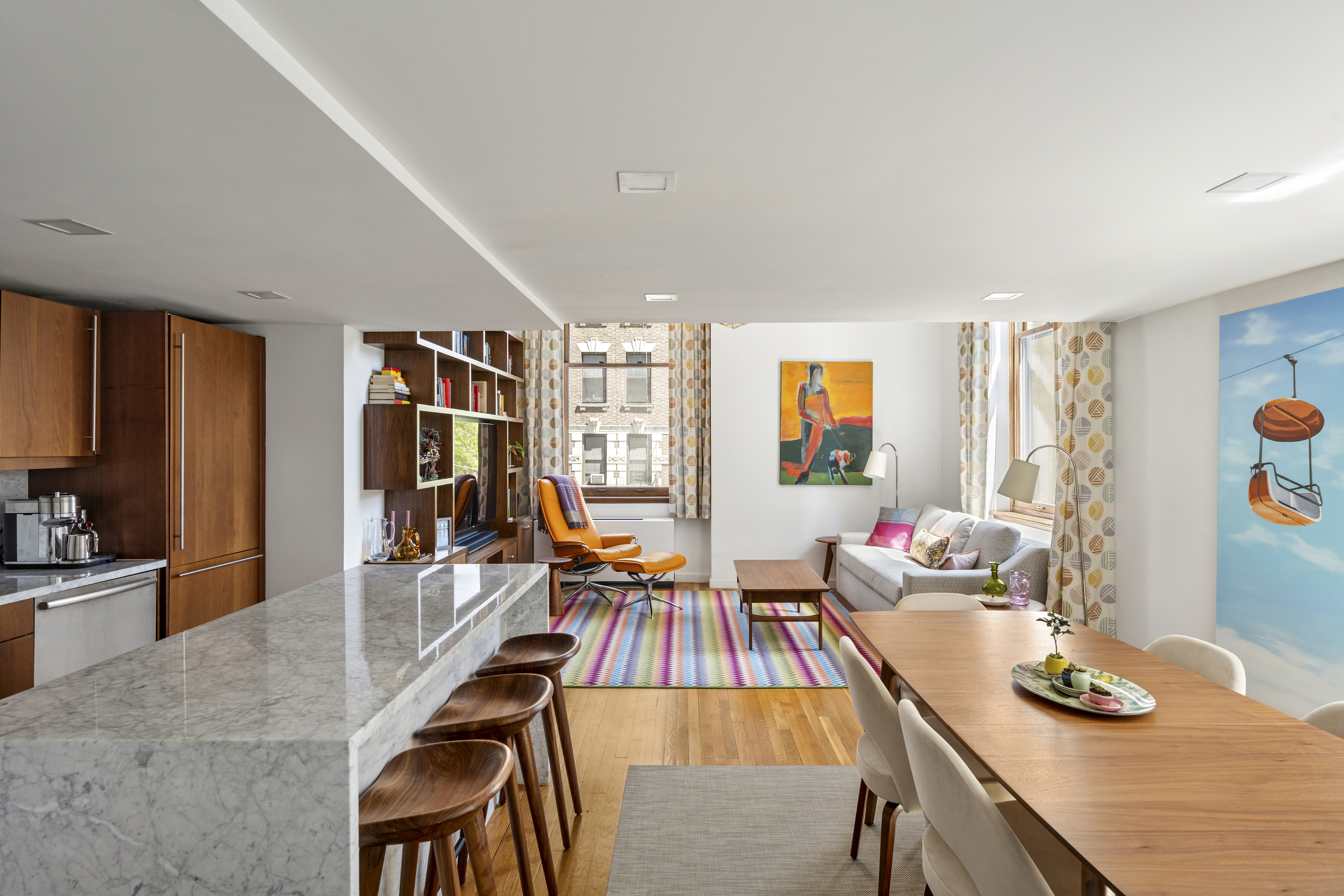 a dining room with furniture and wooden floor