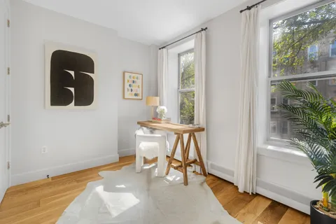 a view of a room with a window and wooden floor