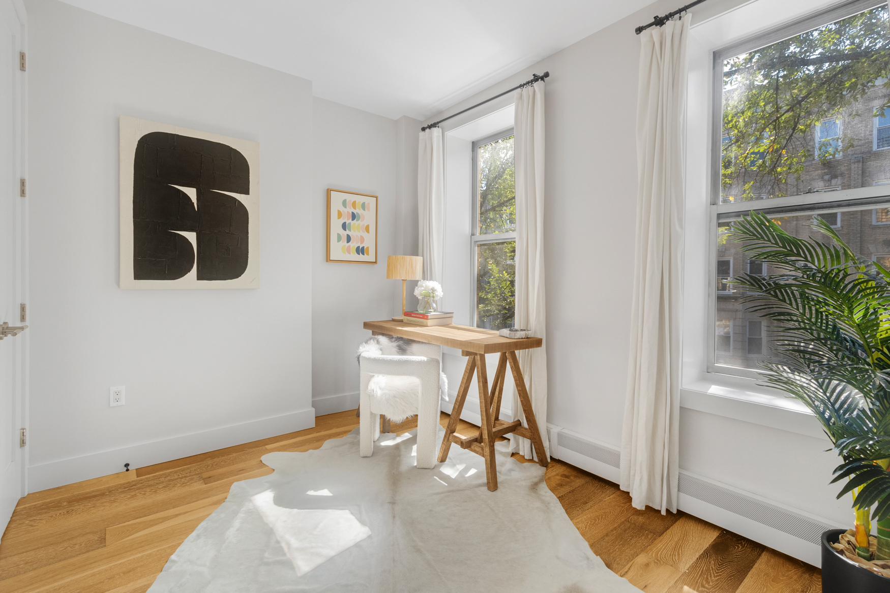 249 Hull Street, Unit 249C Brooklyn, NY 11233 - Photo 12 of 14 a view of a room with a window and wooden floor