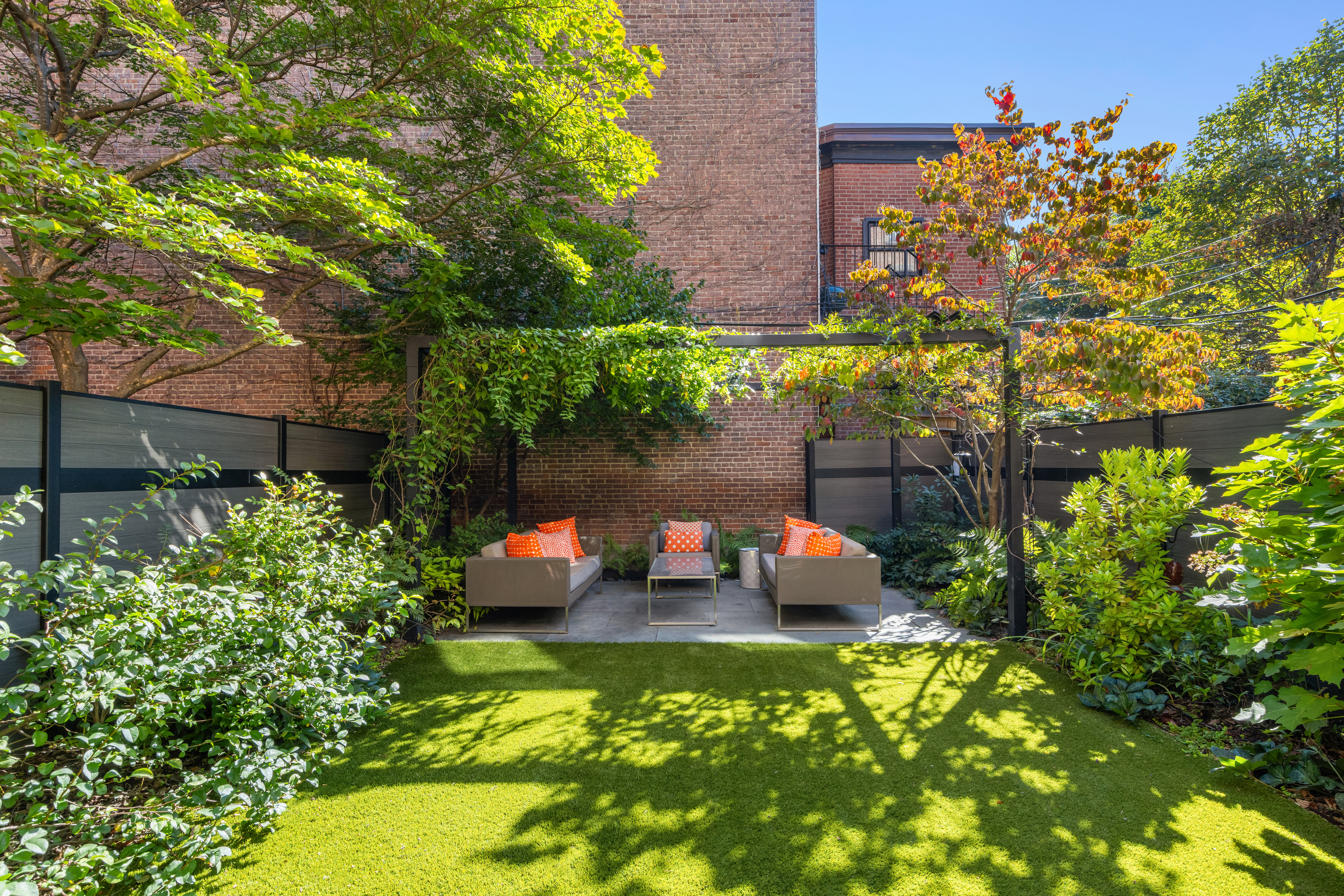 159 6th Avenue, Unit TRIPLEX Brooklyn, NY 11217 - Photo 15 of 19 a backyard of a house with table and chairs and potted plants