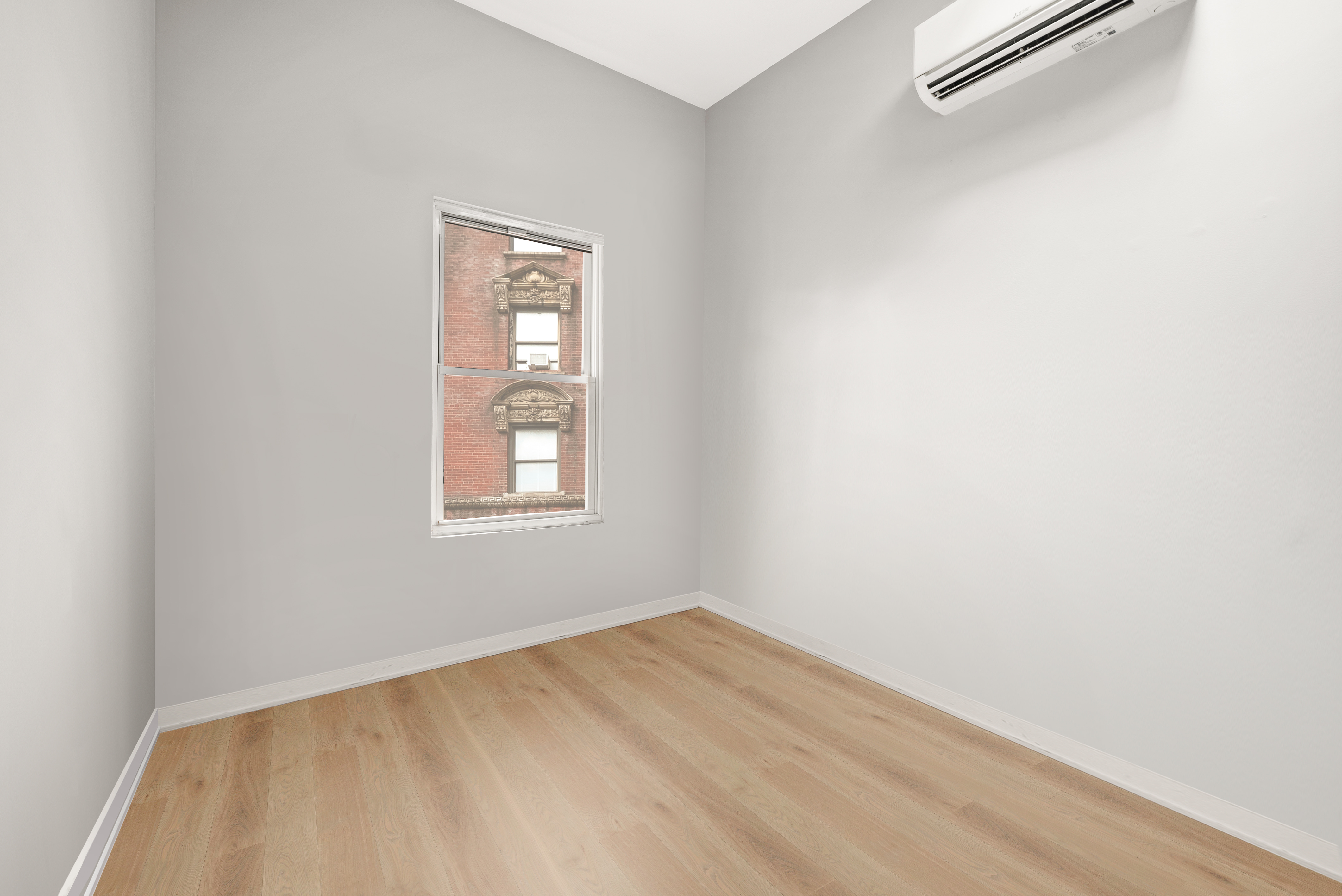 275 Bleecker Street, Unit 4 Manhattan, NY 10014 - Photo 6 of 10 a view of a small space with wooden floor and a window