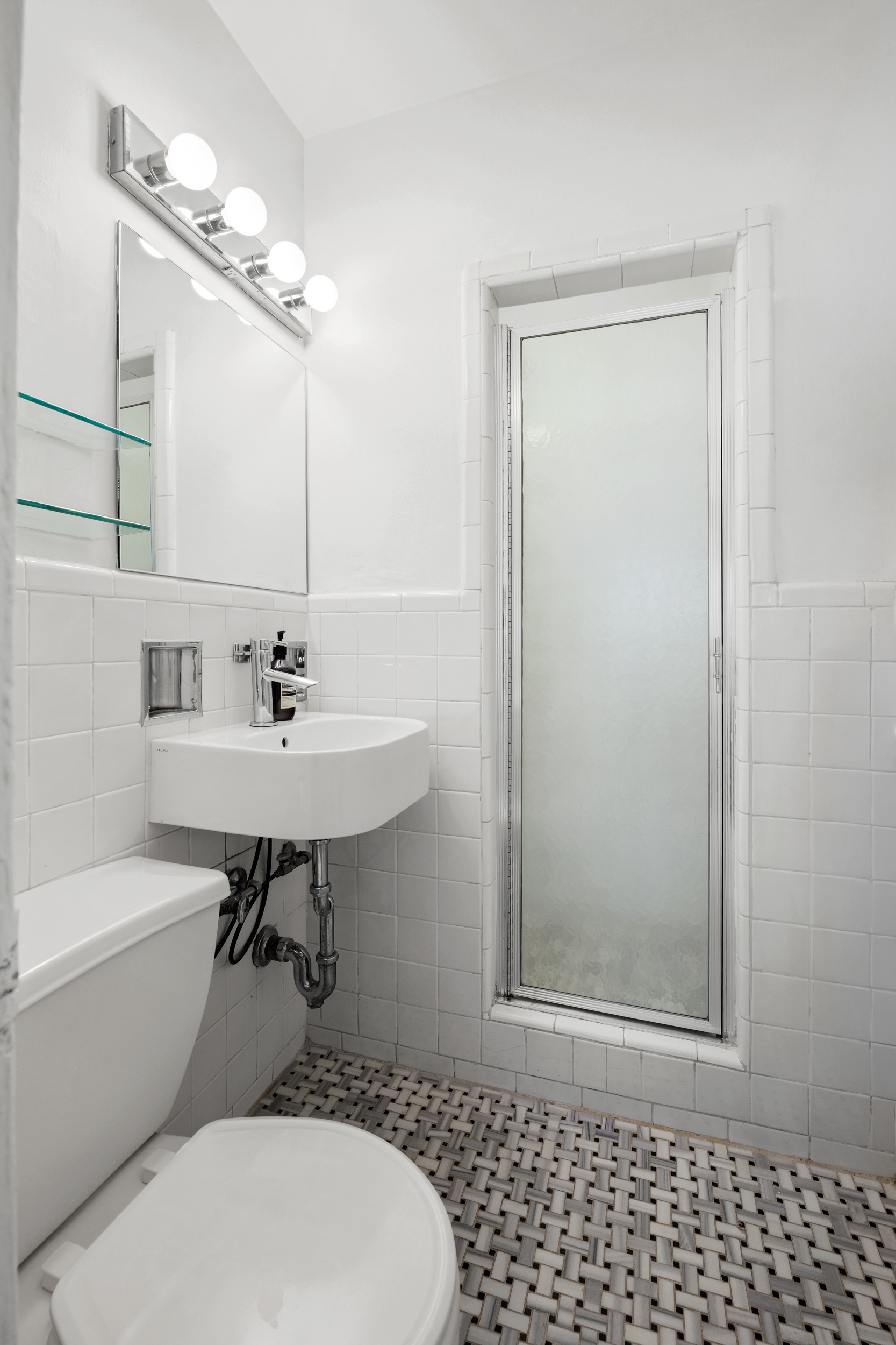 140 7th Avenue, Unit 4L Manhattan, NY 10011 - Photo 11 of 14 a bathroom with a sink a toilet and shower