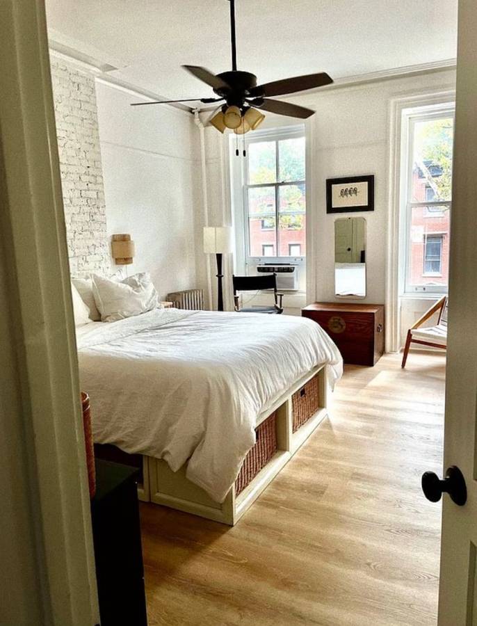 393 Clermont Avenue, Unit 3 Brooklyn, NY 11238 - Photo 7 of 10 a bedroom with a bed and a chandelier