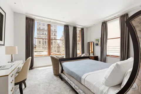 a bedroom with a bed and a large window